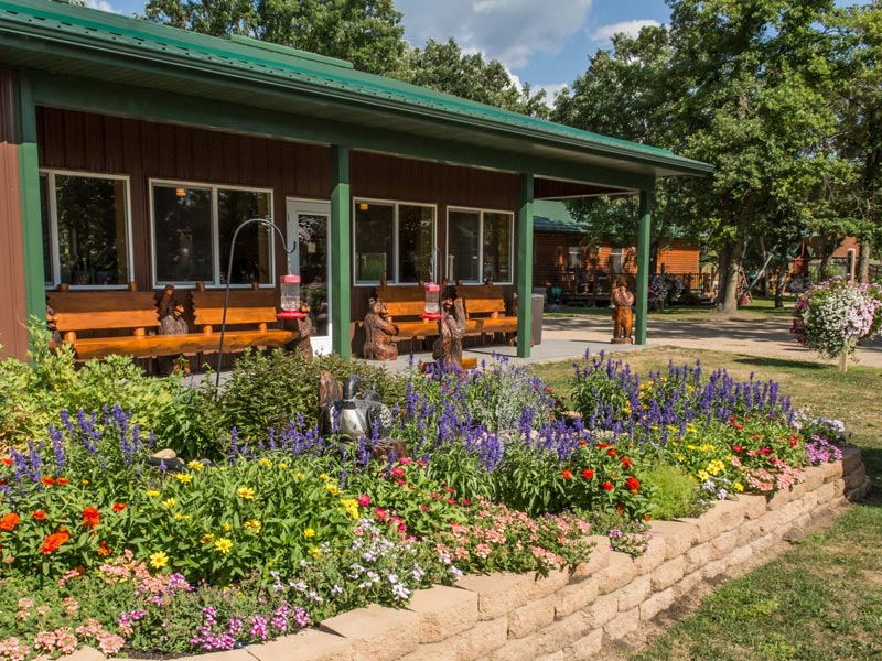 Colorful flower garden in front of rustic lodge