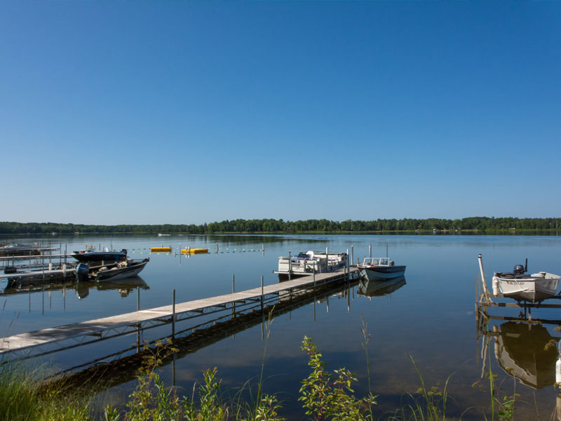 Small boats docked on calm lake